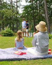 Family enjoying pretty rugged outdoor blanket